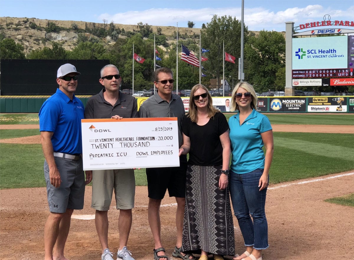 DOWL employees present a check to the St. Vincent Healthcare Foundation